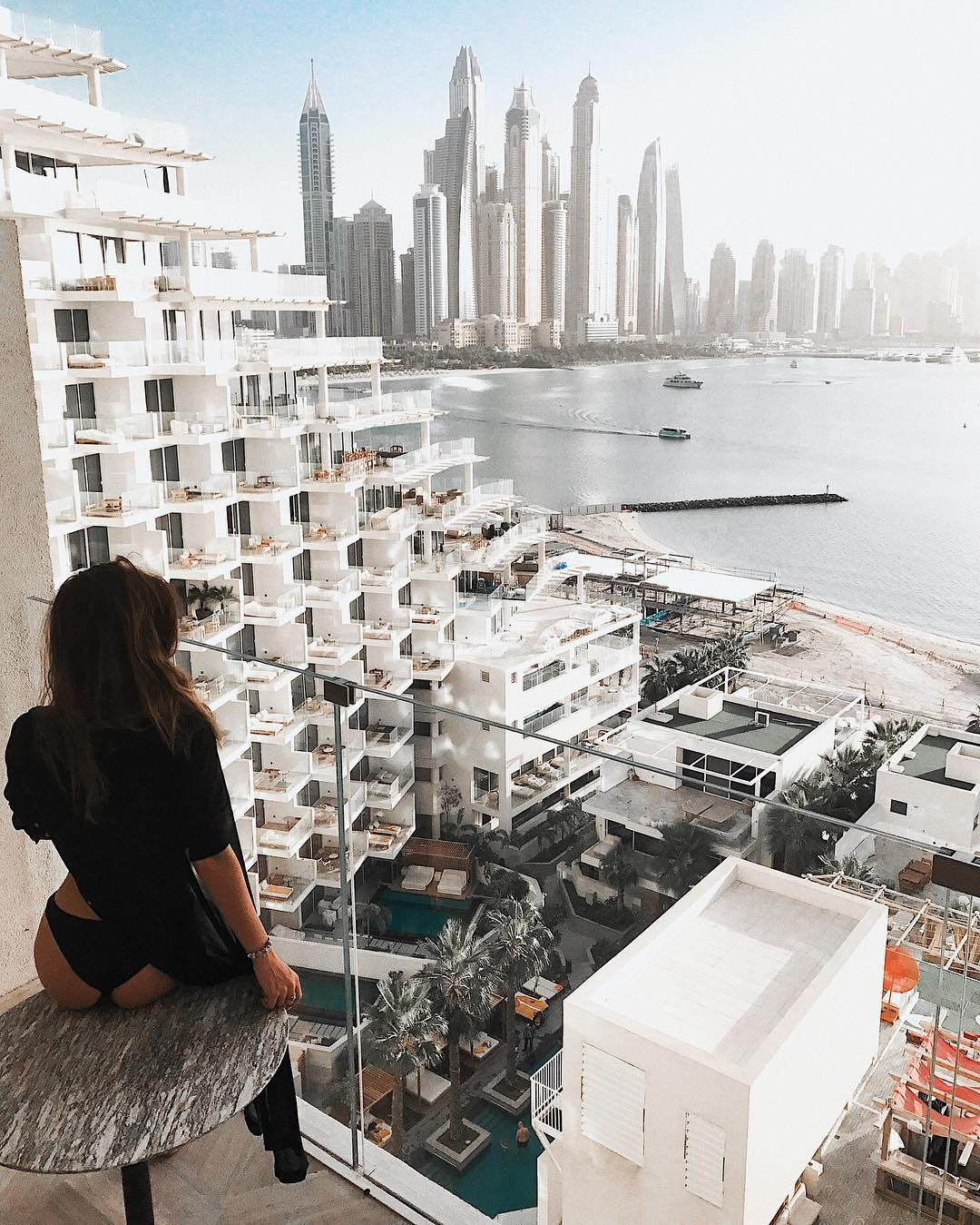 1080x1349, 459 Kb / балкон, стол, небоскрёбы, океан, стекло, бетон